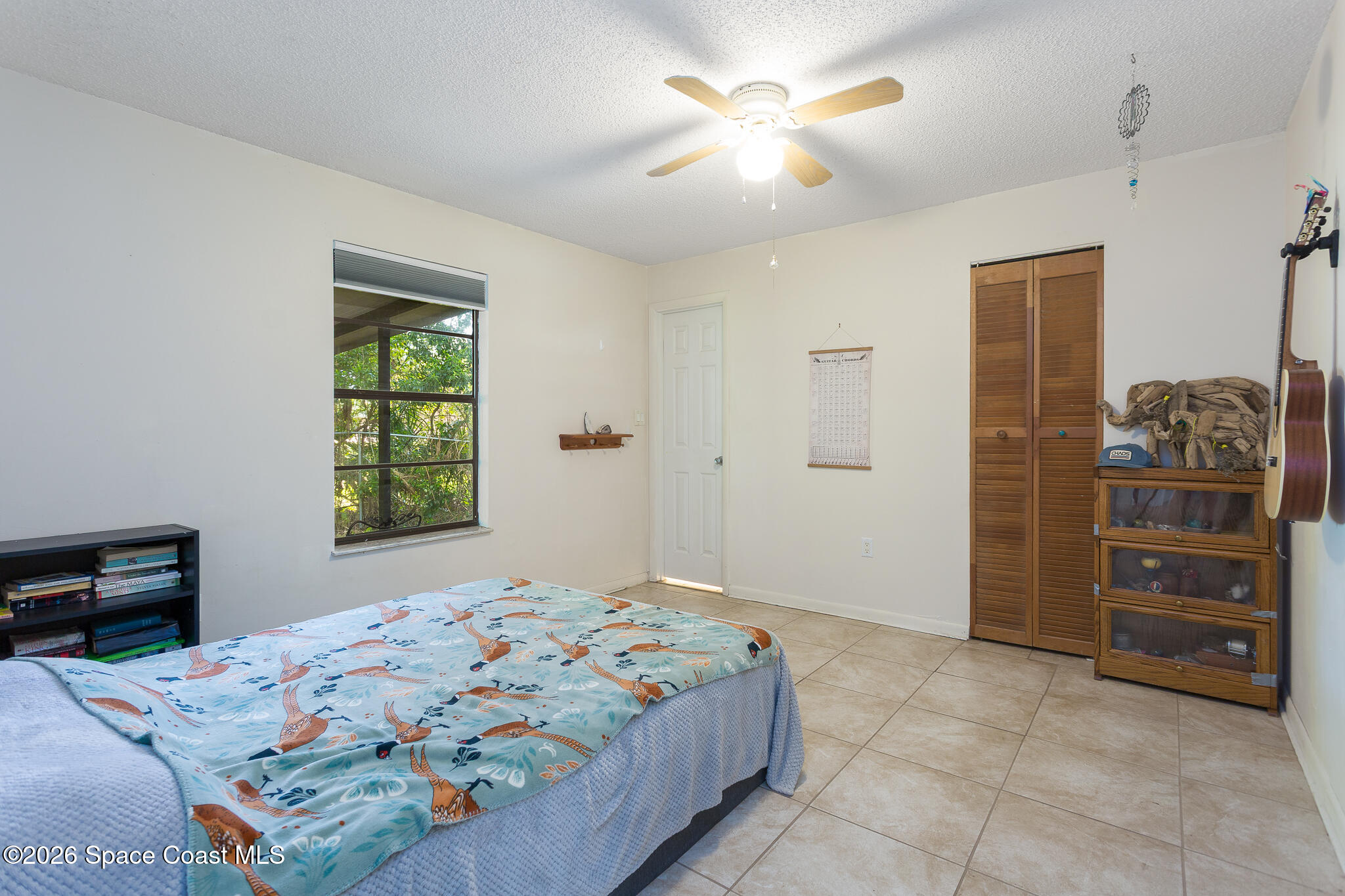 2255 Ladner Road Northeast Palm Bay, FL 32907 - Photo 13 of 22 a bedroom with a bed and a dresser