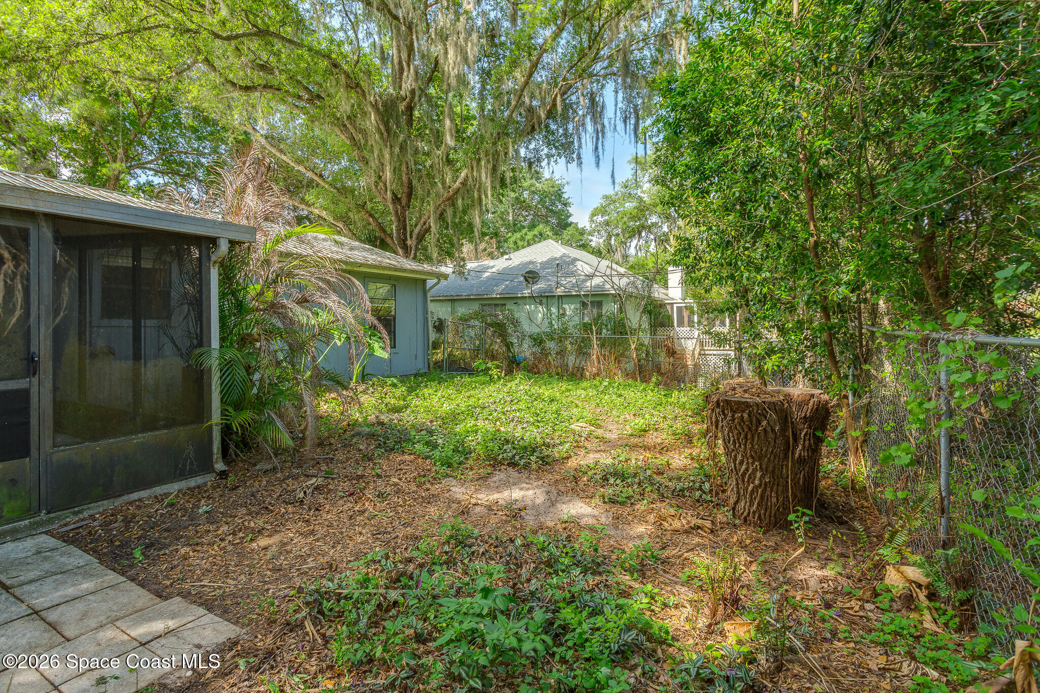 2255 Ladner Road Northeast Palm Bay, FL 32907 - Photo 18 of 22 a backyard of a house with lots of green space