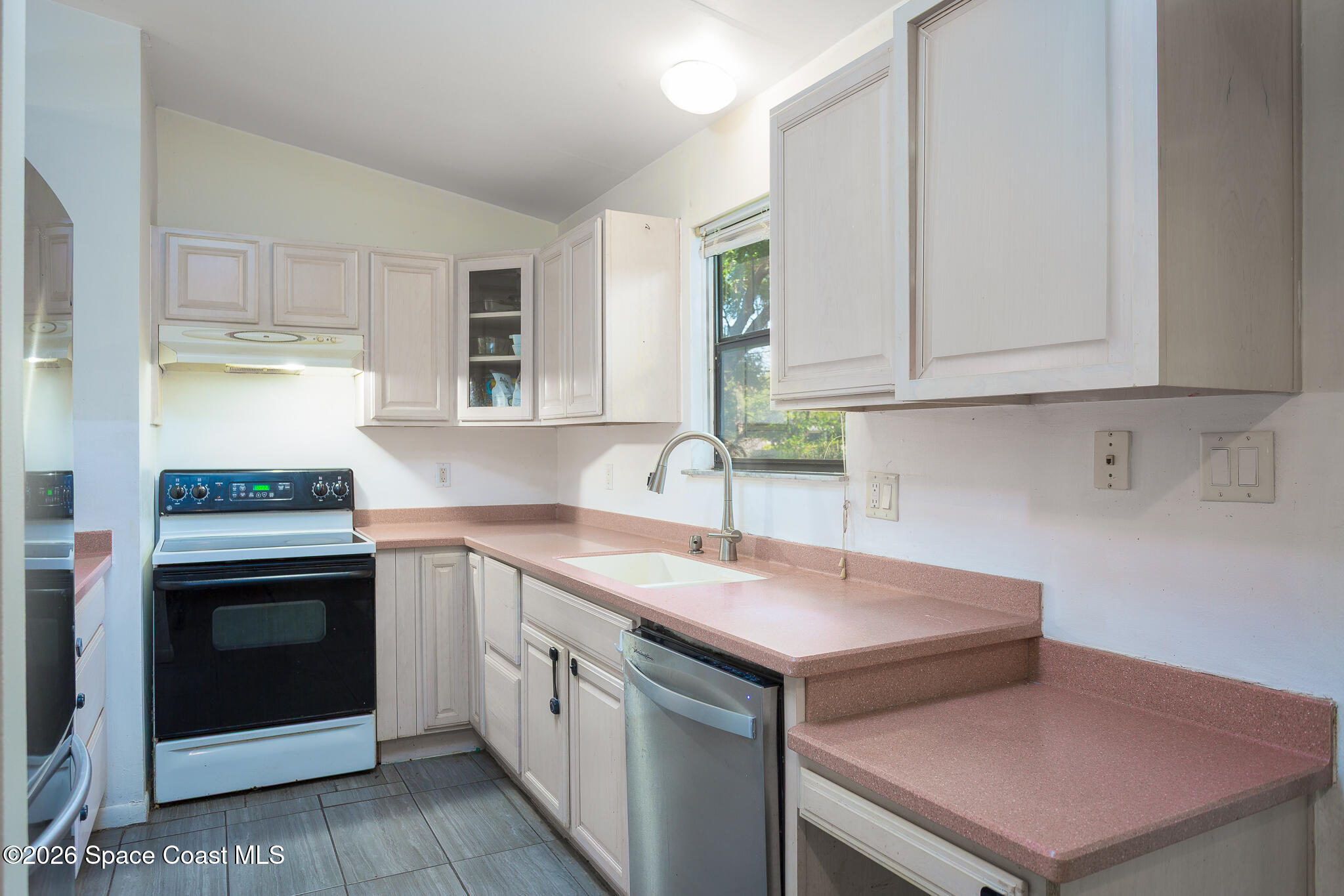 2255 Ladner Road Northeast Palm Bay, FL 32907 - Photo 2 of 22 a kitchen with a sink stove and cabinets