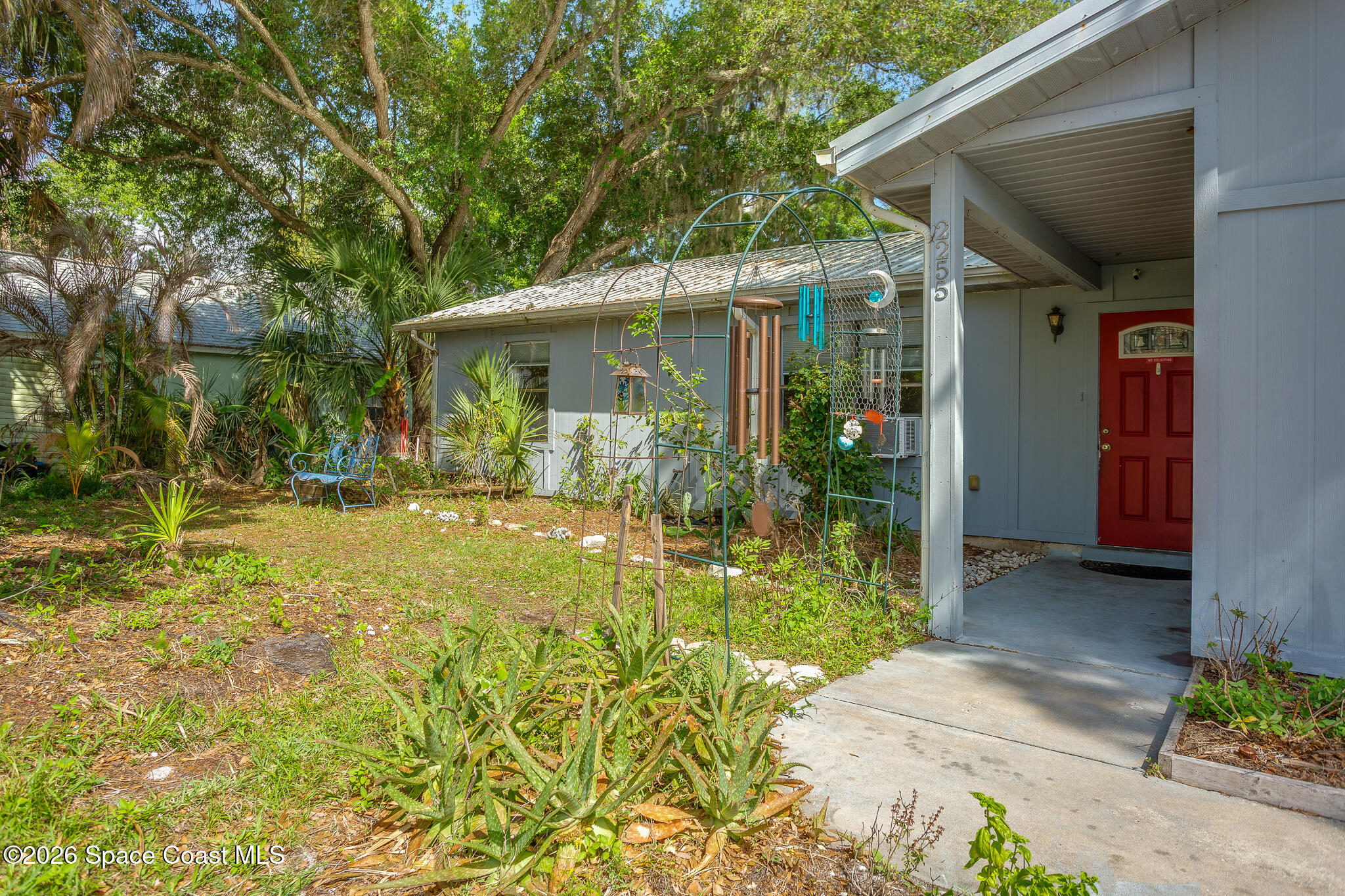 2255 Ladner Road Northeast Palm Bay, FL 32907 - Photo 21 of 22 a backyard of a house with yard and outdoor seating