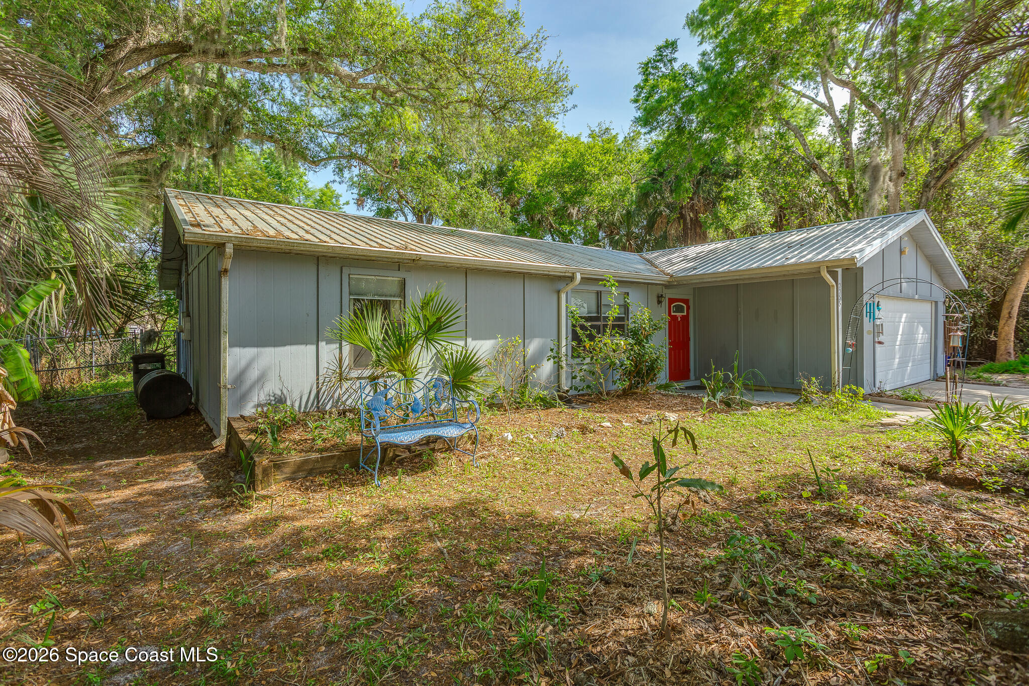 2255 Ladner Road Northeast Palm Bay, FL 32907 - Photo 22 of 22 a view of house with backyard outdoor seating and green space