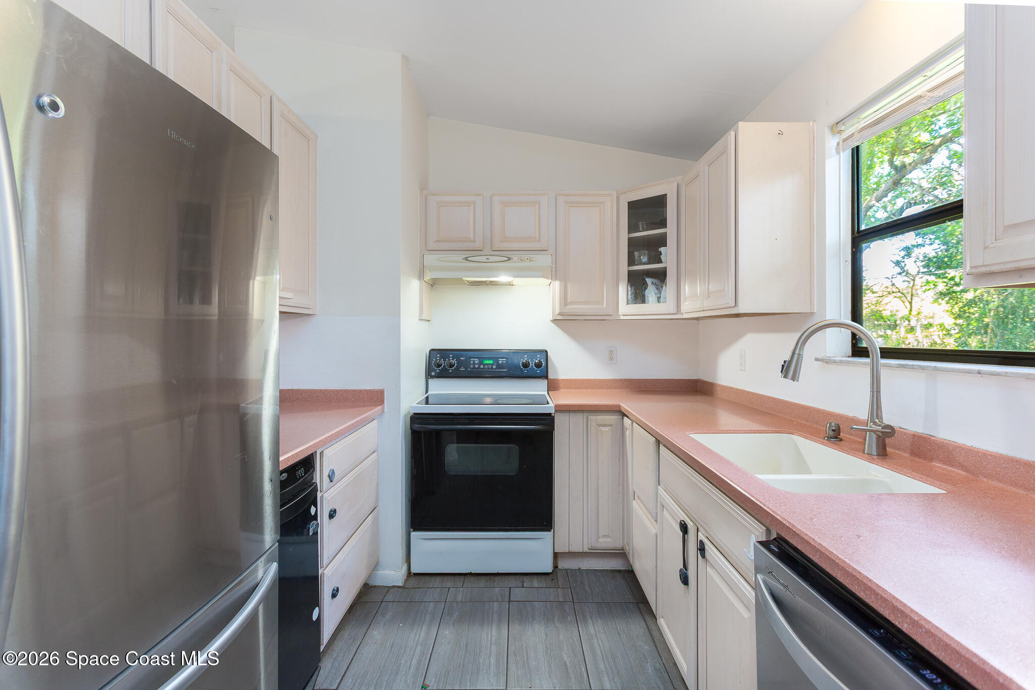 2255 Ladner Road Northeast Palm Bay, FL 32907 - Photo 3 of 22 a kitchen with granite countertop a sink stove and refrigerator