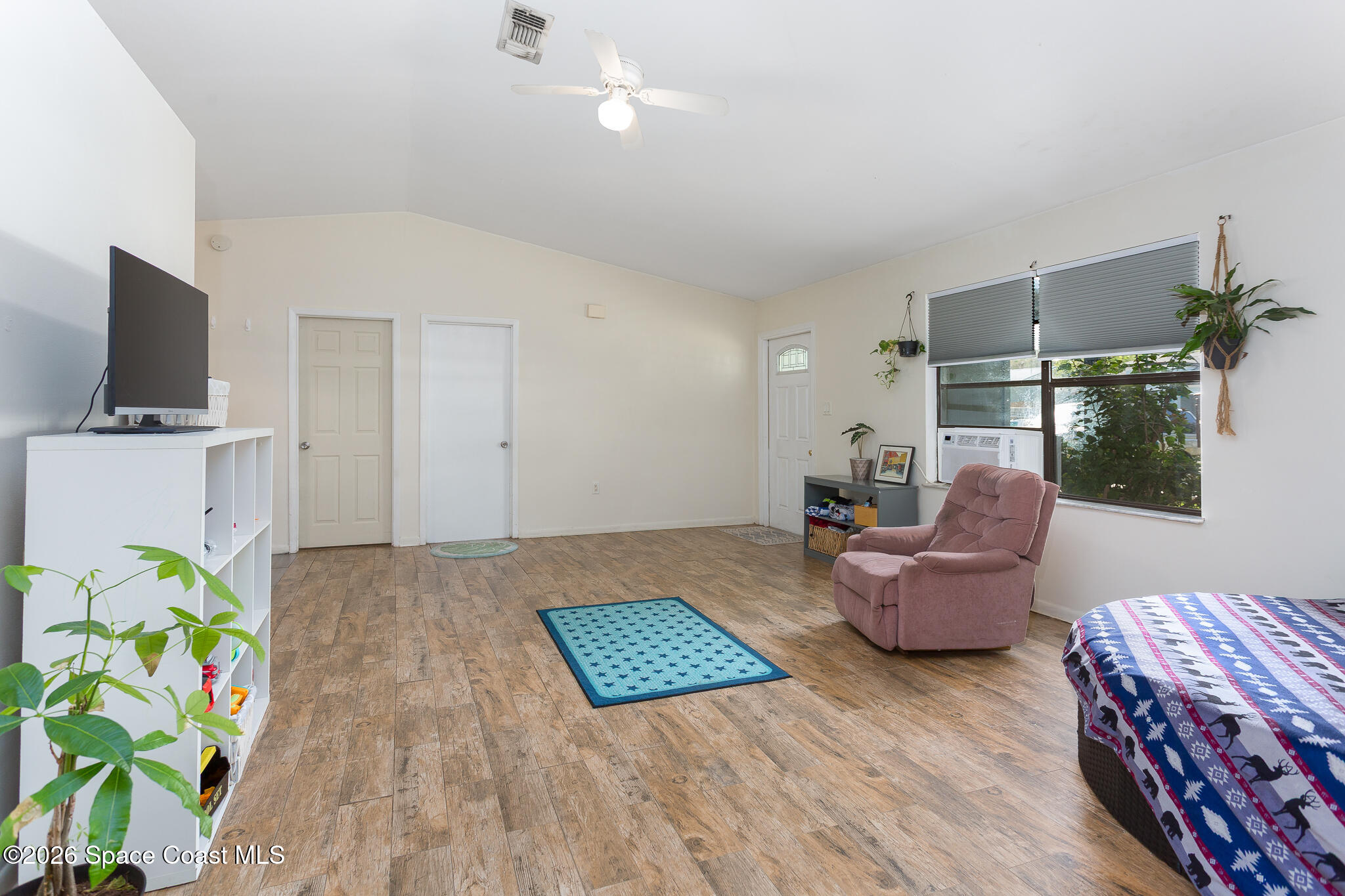 2255 Ladner Road Northeast Palm Bay, FL 32907 - Photo 6 of 22 a living room with furniture and a flat screen tv