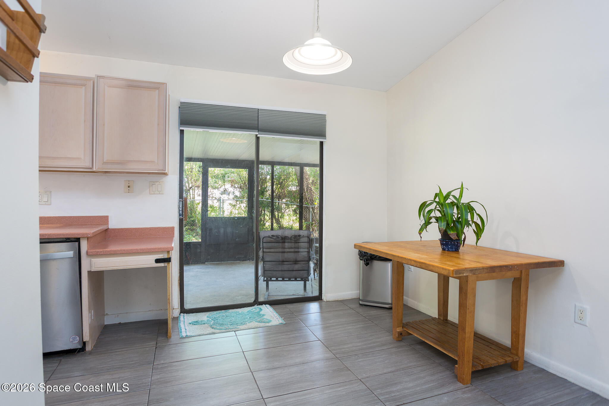 2255 Ladner Road Northeast Palm Bay, FL 32907 - Photo 7 of 22 a room with a table and a chandelier
