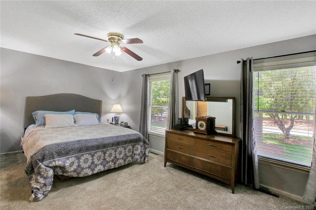 220 South Mccoy Road Salisbury, NC 28144 - Photo 9 of 46 a bedroom with a bed and large mirror