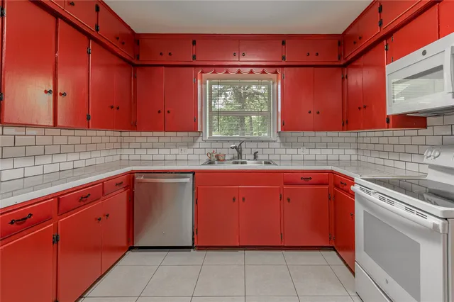 a kitchen with stainless steel appliances granite countertop a sink and cabinets