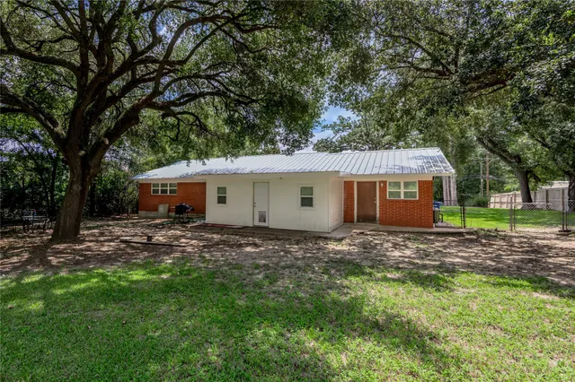 a house view with a sitting space and garden