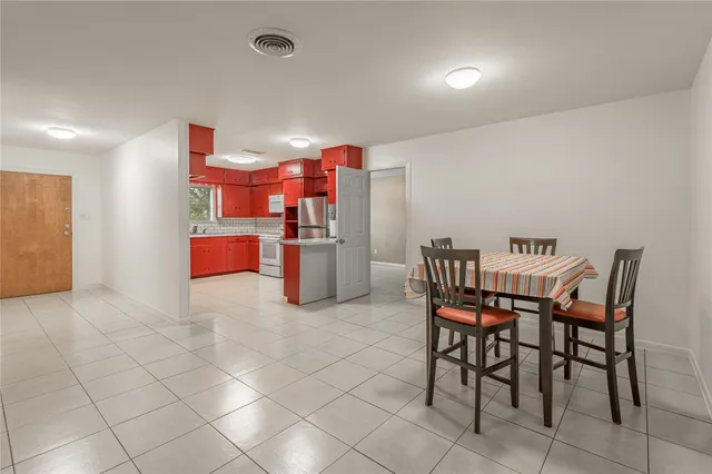 a kitchen with a sink a refrigerator and cabinets