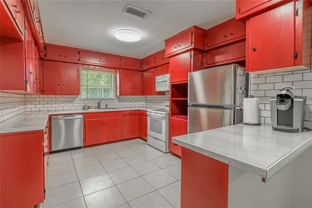 a kitchen with stainless steel appliances granite countertop a sink and cabinets