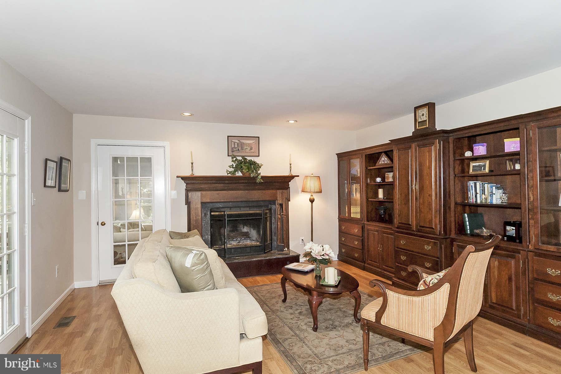14903 Peach Orchard Road Silver Spring, MD 20905 - Photo 14 of 30 a living room with furniture a rug and a fireplace