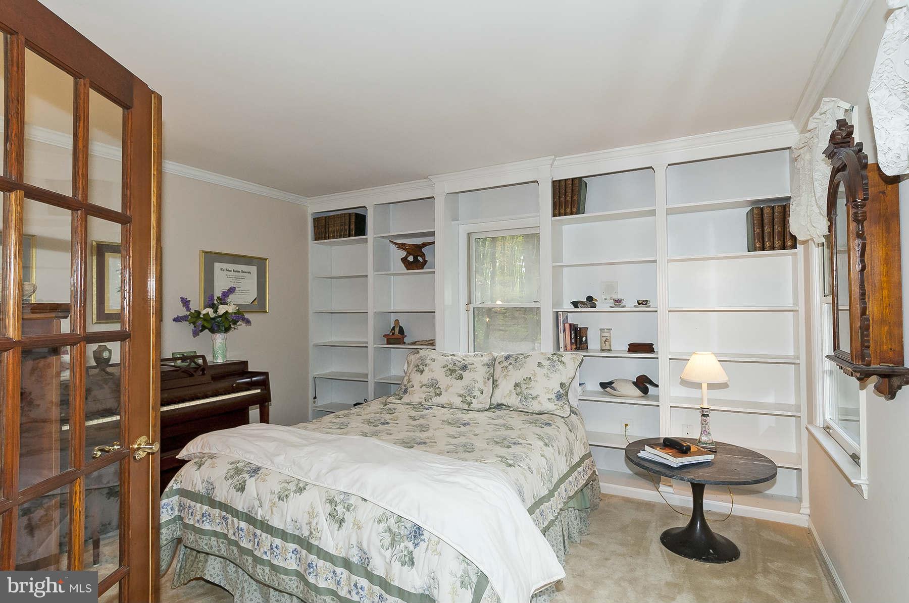14903 Peach Orchard Road Silver Spring, MD 20905 - Photo 6 of 30 a bedroom with a bed and a cabinets