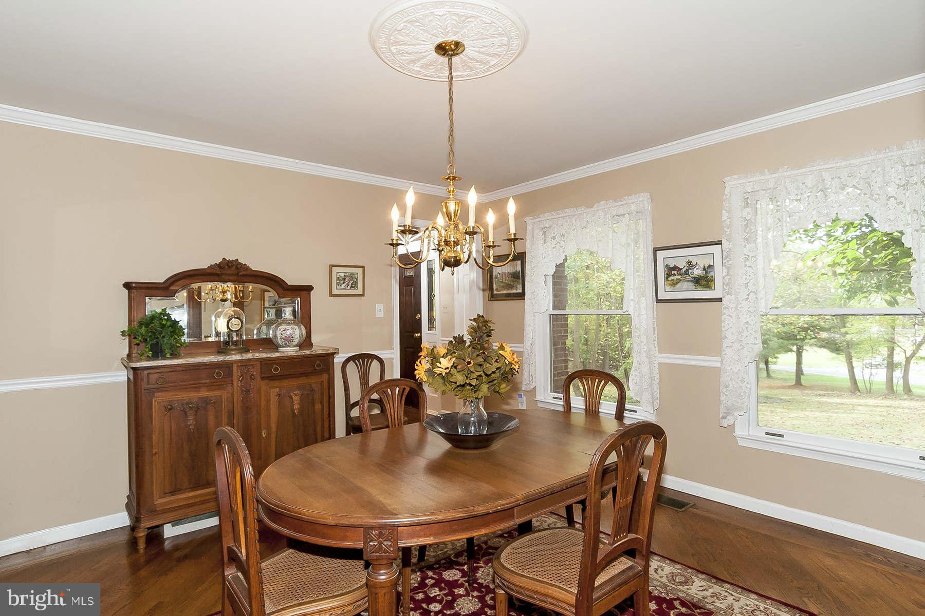 14903 Peach Orchard Road Silver Spring, MD 20905 - Photo 8 of 30 a view of a dining room with furniture a chandelier and wooden floor