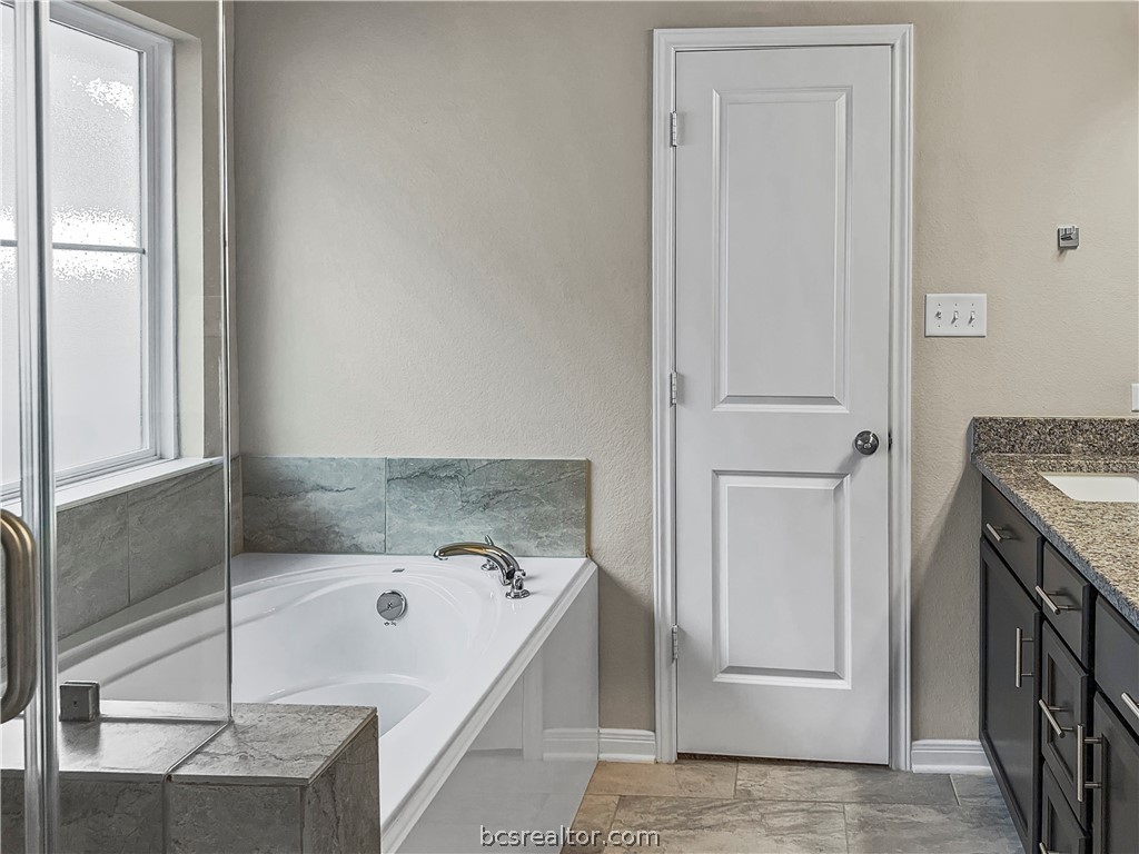 1971 Chief Street Bryan, TX 77807 - Photo 12 of 14 a bathroom with a tub and a shower