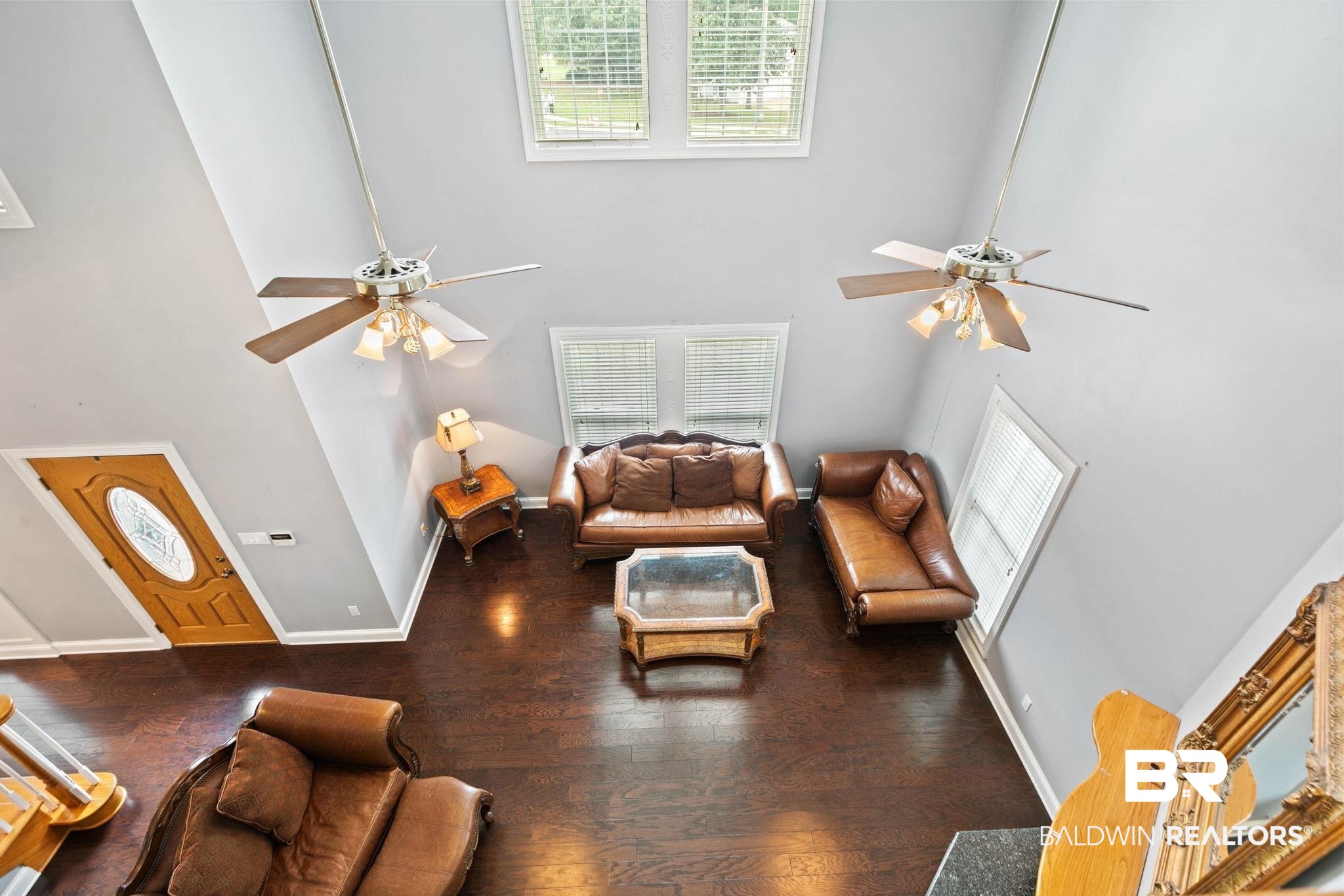 2 Speckle Trout Route Daphne, AL 36527 - Photo 26 of 61 Living room with ceiling fan, hardwood / wood-style flooring, healthy amount of natural light, and a high ceiling