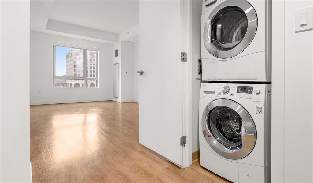 99 Kneeland Street, Unit 611 Boston, MA 02111 - Photo 6 of 15 a view of a hallway with washer and dryer