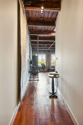 a kitchen with fireplace and wooden floor