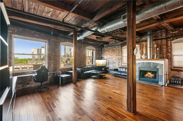 a kitchen with fireplace and wooden floor