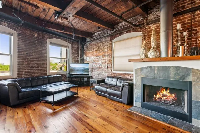 a room with stainless steel appliances granite countertop a refrigerator and wooden cabinets