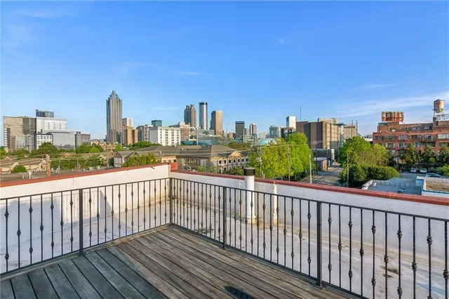 a kitchen with stainless steel appliances kitchen island granite countertop a table chairs and a refrigerator
