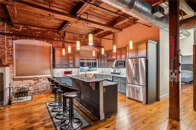 a view of water heater room with wooden floor
