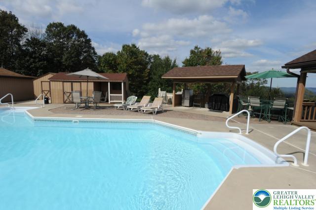 3511 Timber Lane Slatington, PA 18080 - Photo 12 of 27 a patio with a table and chairs under an umbrella