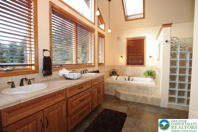 3511 Timber Lane Slatington, PA 18080 - Photo 18 of 27 a bathroom with a double vanity sink large mirror and a bathtub