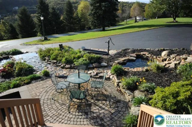 a view of a chair and table on the garden