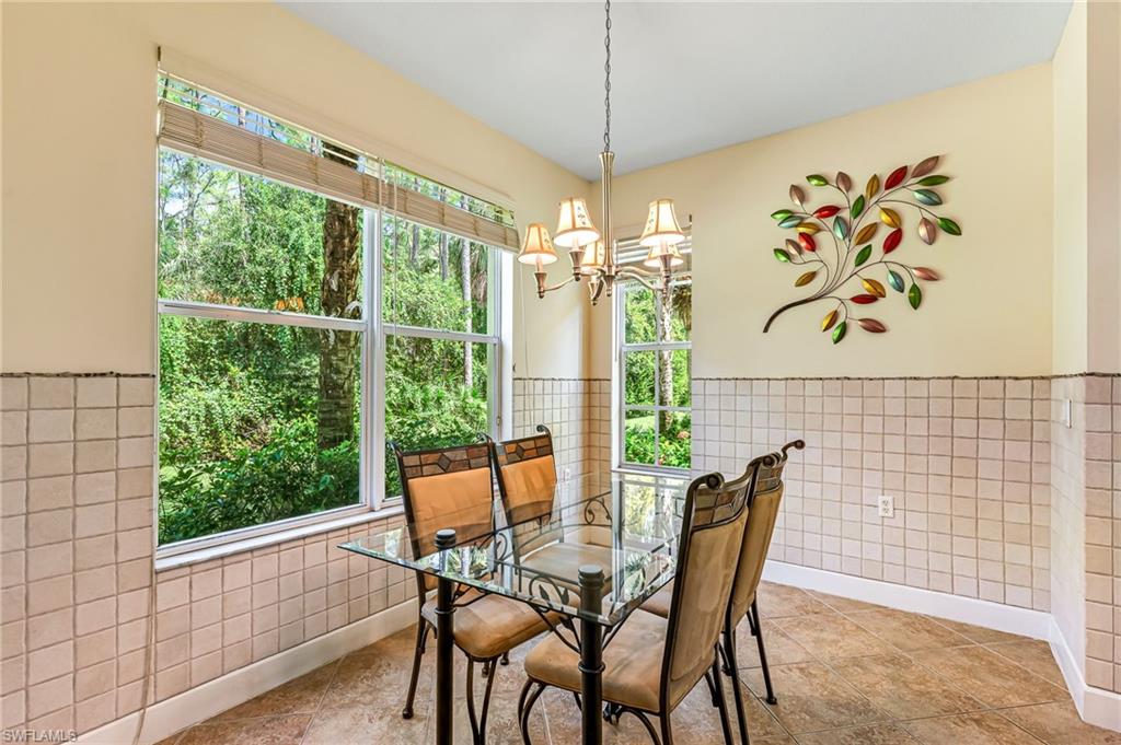 26437 Lucky Stone Road, Unit 102 Bonita Springs, FL 34135 - Photo 11 of 25 a view of a dining room with furniture window and outside view