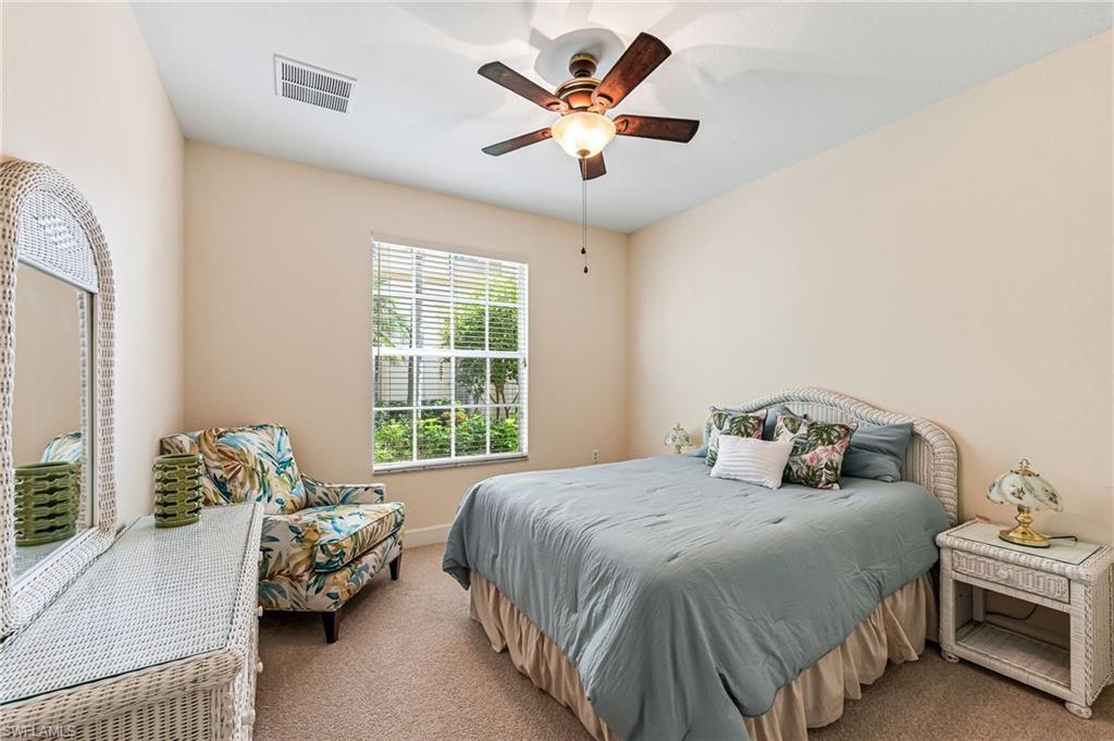 26437 Lucky Stone Road, Unit 102 Bonita Springs, FL 34135 - Photo 16 of 25 a bedroom with a bed and furniture