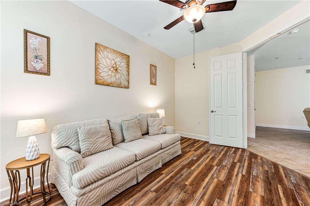 26437 Lucky Stone Road, Unit 102 Bonita Springs, FL 34135 - Photo 20 of 25 a living room with furniture and a rug