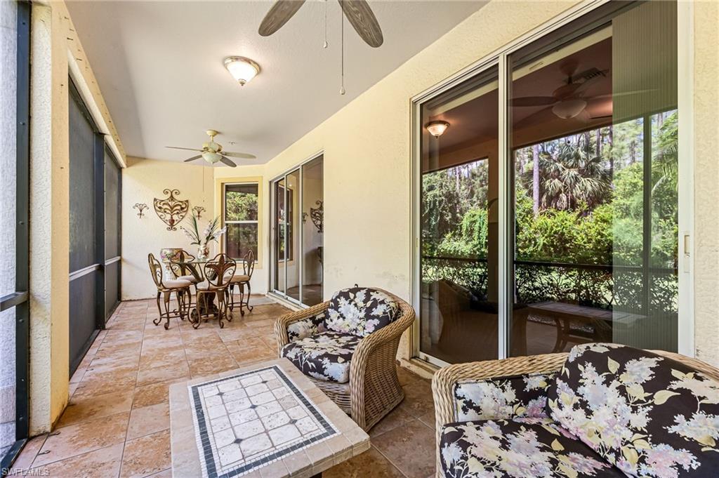 26437 Lucky Stone Road, Unit 102 Bonita Springs, FL 34135 - Photo 23 of 25 a bedroom with furniture and large windows