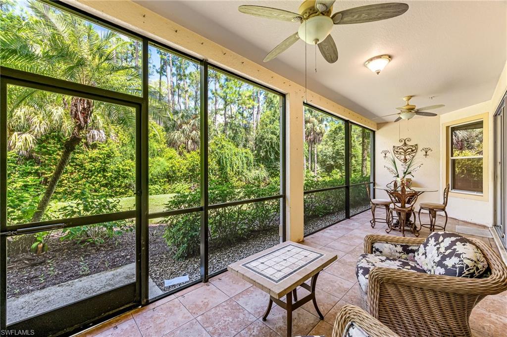 26437 Lucky Stone Road, Unit 102 Bonita Springs, FL 34135 - Photo 24 of 25 a living room with furniture and a floor to ceiling window