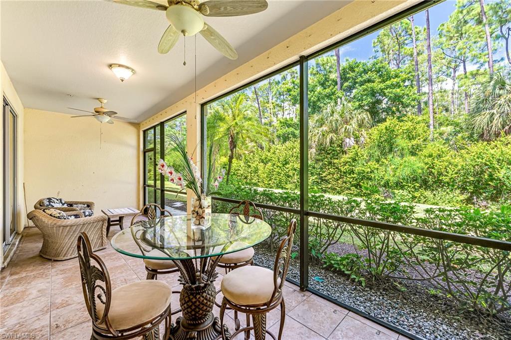 26437 Lucky Stone Road, Unit 102 Bonita Springs, FL 34135 - Photo 25 of 25 a dining room with furniture a chandelier and wooden floor