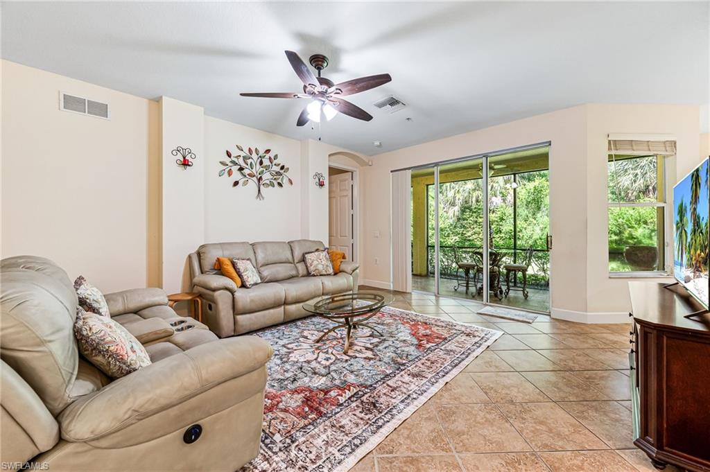 26437 Lucky Stone Road, Unit 102 Bonita Springs, FL 34135 - Photo 3 of 25 a living room with furniture and a large window