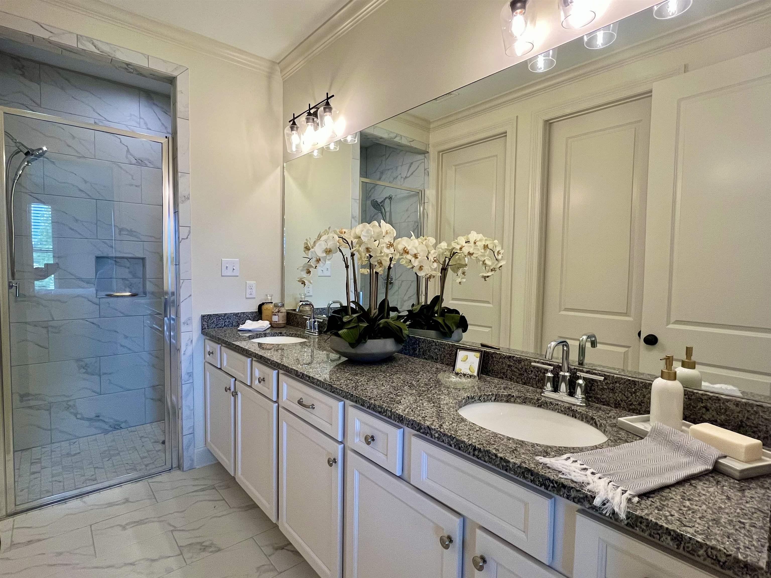 558 Ashburn Drive Collierville, TN 38017 - Photo 12 of 21 a bathroom with a granite countertop double vanity sink and a mirror
