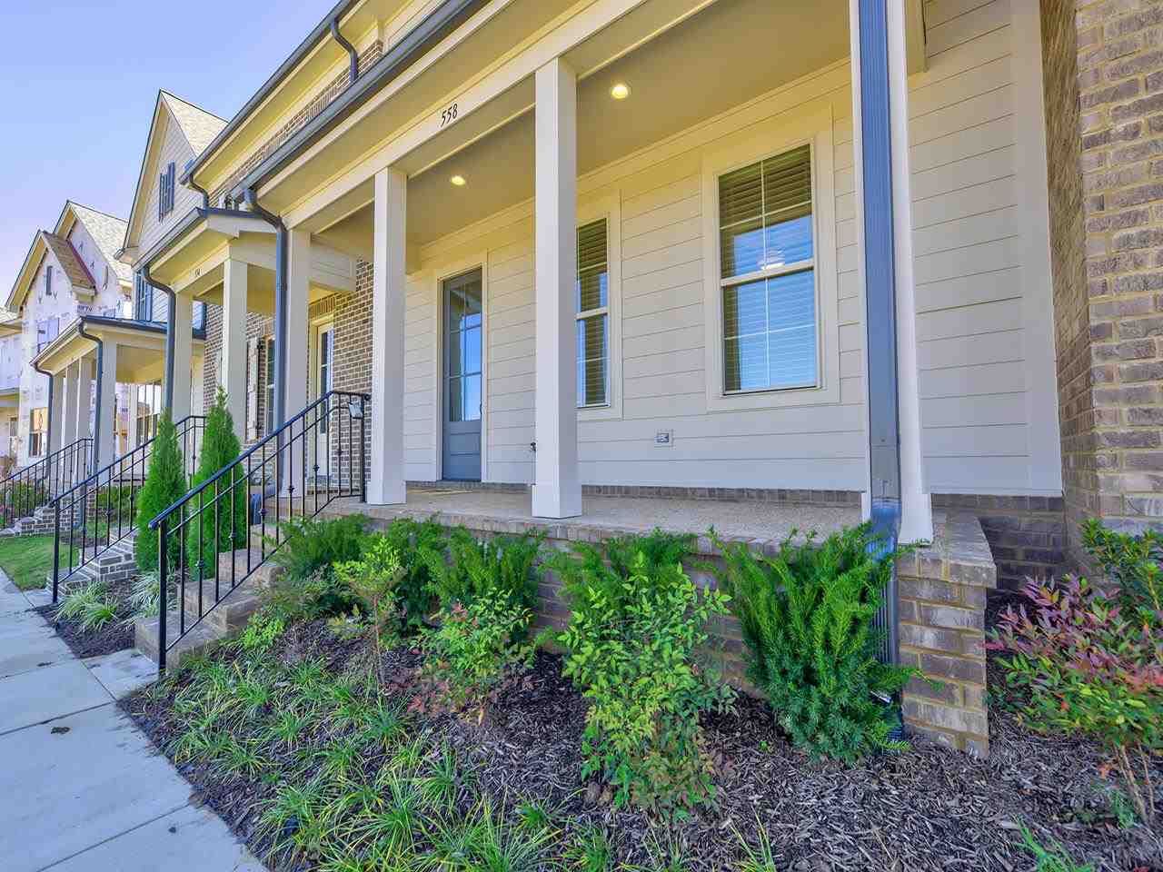 558 Ashburn Drive Collierville, TN 38017 - Photo 3 of 21 a view of a brick house with plants and large windows