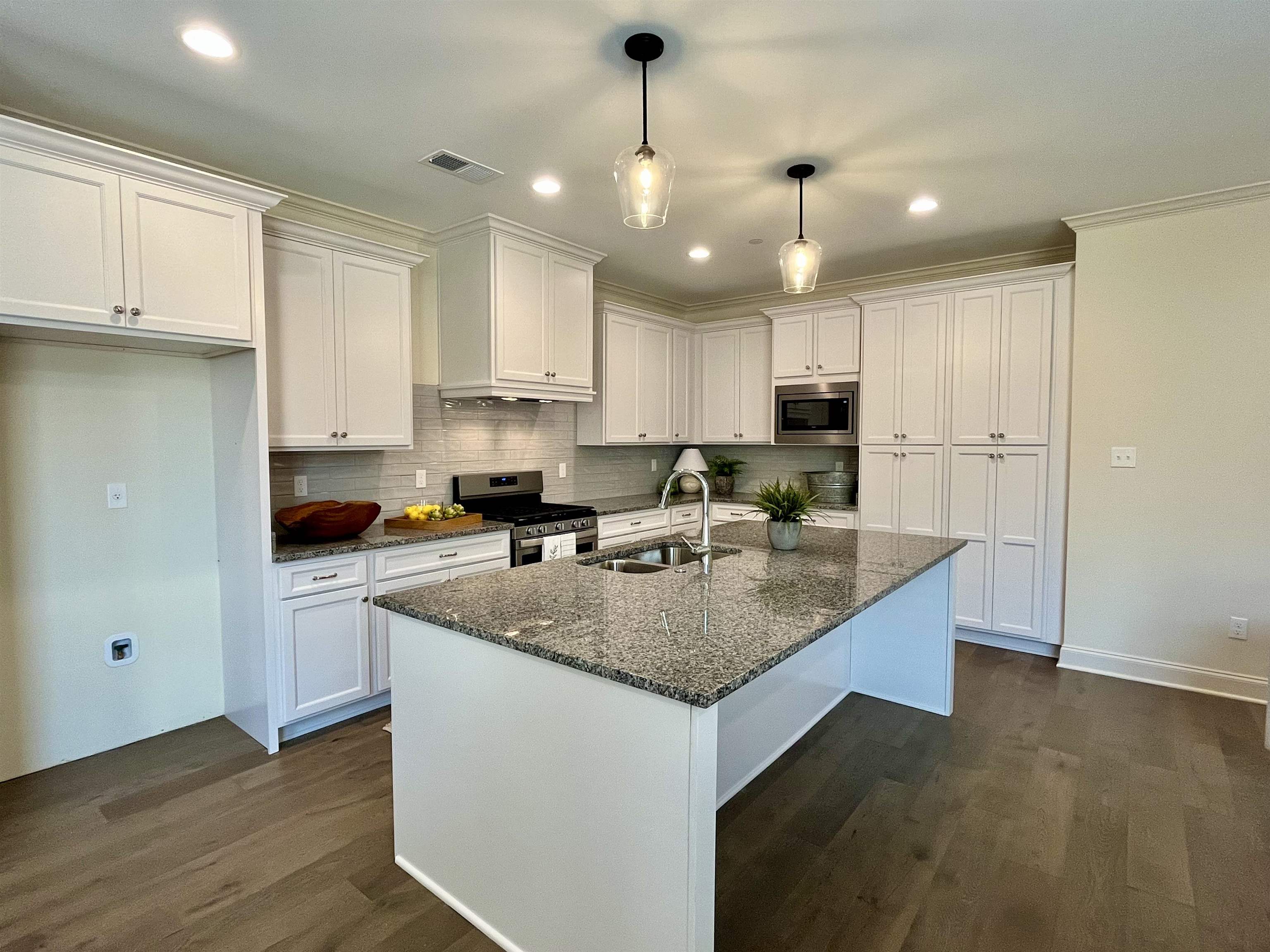 558 Ashburn Drive Collierville, TN 38017 - Photo 9 of 21 a kitchen with kitchen island granite countertop a sink a center island and cabinets
