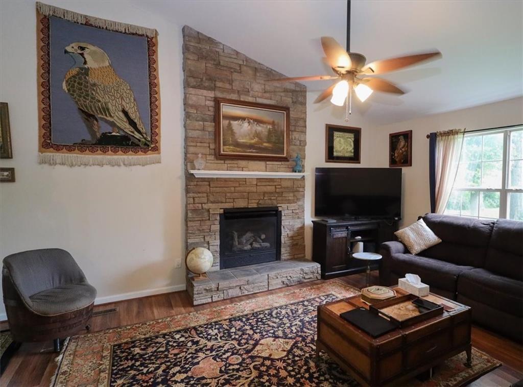 236 Hiram Sudie Road Dallas, GA 30157 - Photo 6 of 26 a living room with furniture a flat screen tv and a fireplace