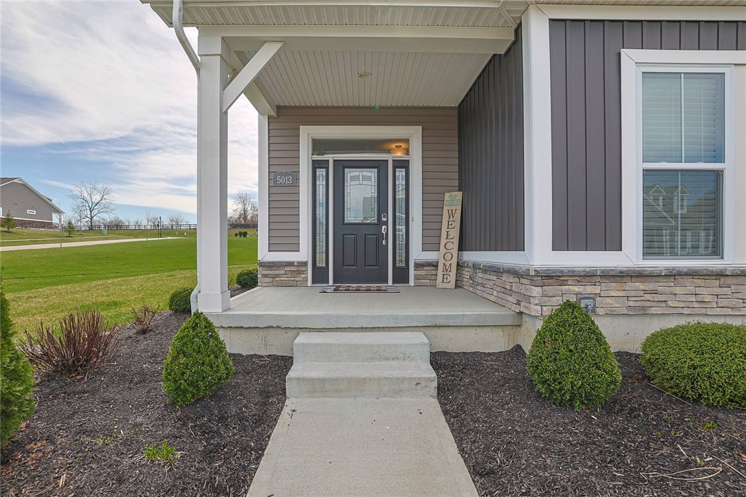 5013 Arena Court Hamilton, OH 45011 - Photo 2 of 41 The welcoming entryway features a covered porch and neatly maintained landscaping.