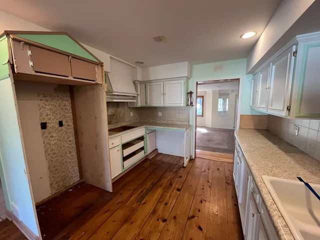 a kitchen with granite countertop stainless steel appliances a counter top space and cabinets