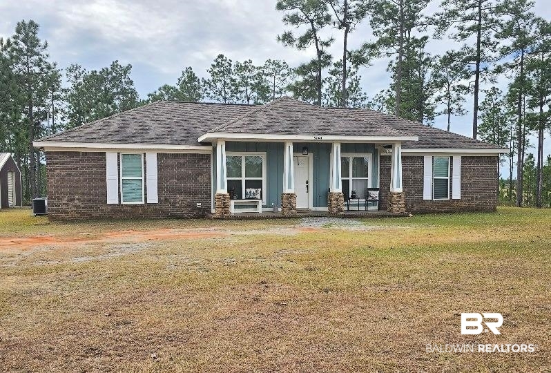 52041 Robert White Road Bay Minette, AL 36507 - Photo 1 of 16 View of front facade featuring covered porch, a front yard, and cooling unit