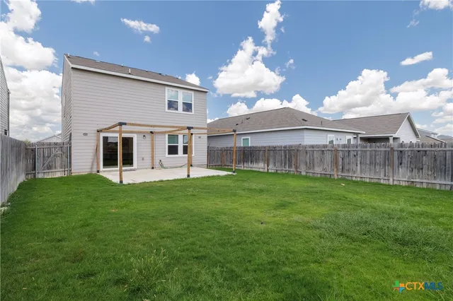 a view of a house with a backyard