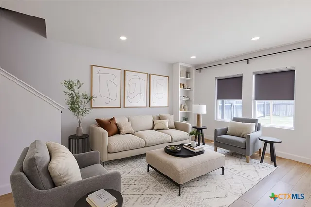 a living room with furniture and a large window
