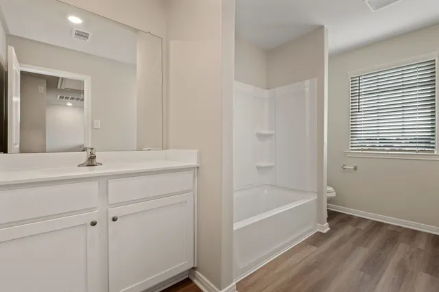a bathroom with a bathtub and a sink