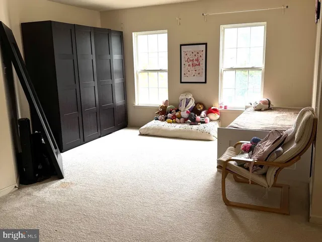 a bedroom with furniture and a window