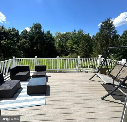 a view of terrace with seating area and trees