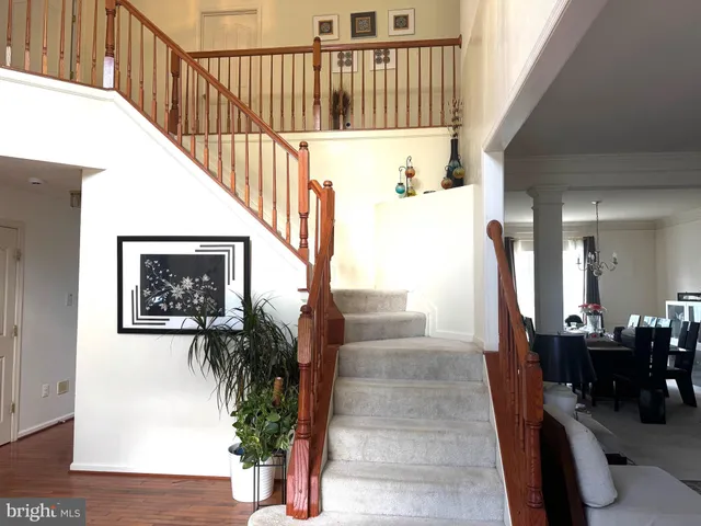 a view of staircase with furniture and wooden floor