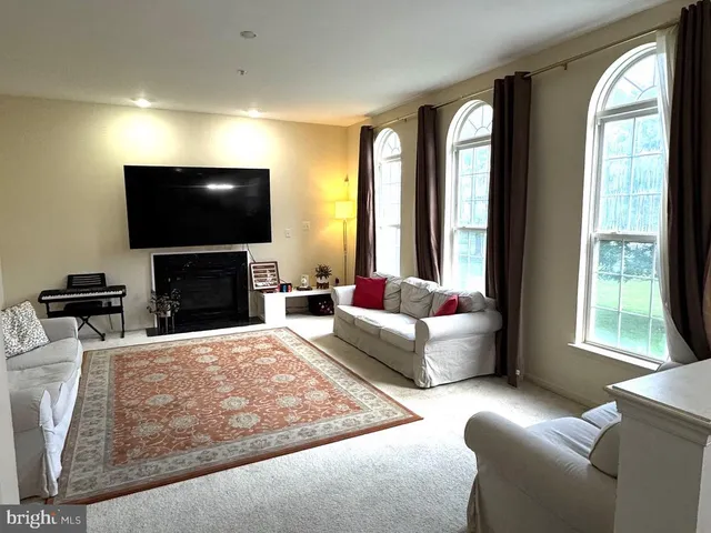 a living room with fireplace furniture and a flat screen tv