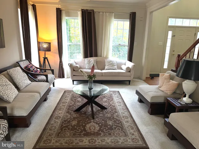 a living room with furniture fireplace and a table