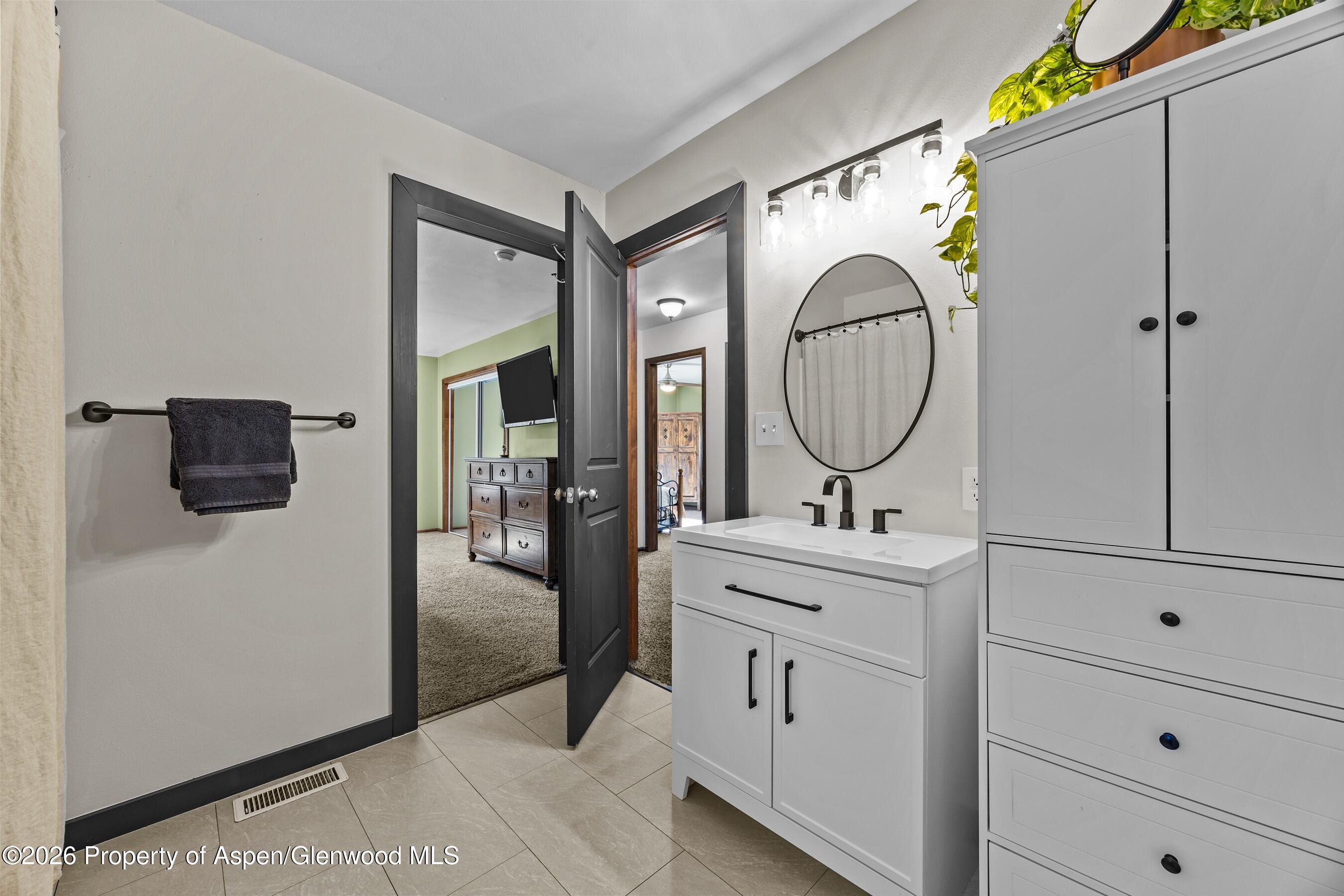 212 Safflower Court New Castle, CO 81647 - Photo 14 of 27 a bathroom with a sink and a mirror